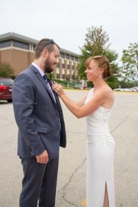 Bride helps with flowers to groom, Courthouse